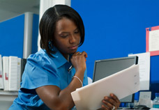 Female office worker doing paperwork. Physical and Cognitive Assessments for help in the work environment.