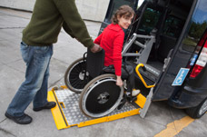 Female wheelchair user using adapted vehicle. Occupational Health Assessment and advice on vehicles.