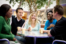 Group of friends chatting in cafe. Neurological Rehabilitation Services in South London. 