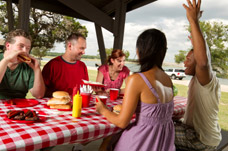 Friends chatting while picnicking. How our Neurorehabilitation can improve people's lives.