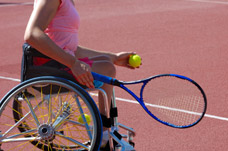 Male wheelchair user playing tennis. Neurorehabilitation treatment and programmes to help with activities.