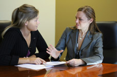 Two women in a business meeting. Training to help family members in a therapeutic way to help achieve goals.