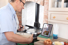 Man using ipad to follow a recipe. Neuro rehabilitiation to help with cognitive functions. 